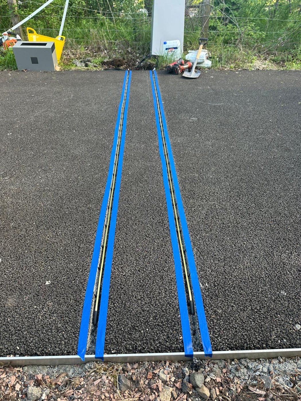Sensor cable channels marked out with tape ahead of installation