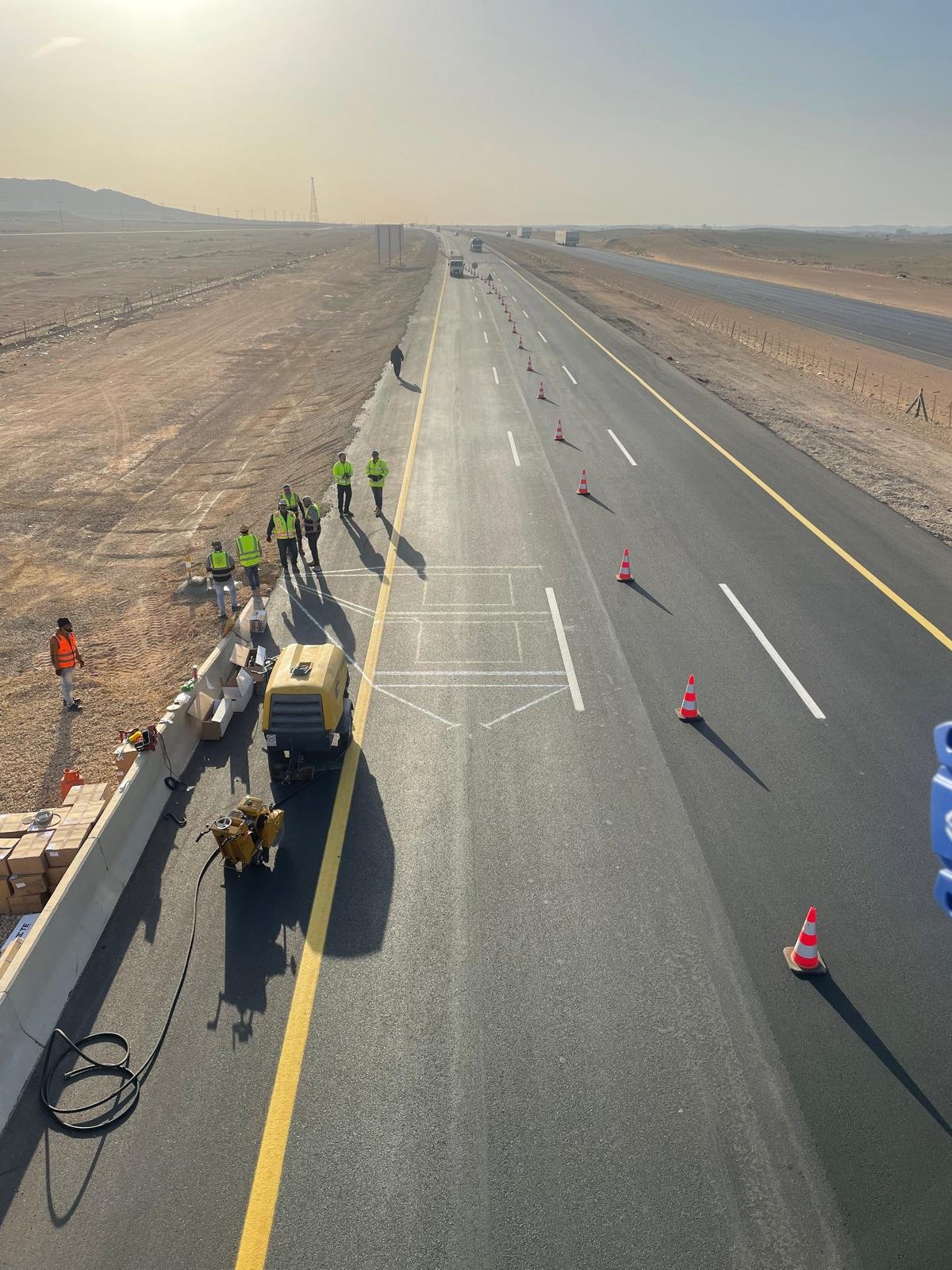 Field team marking out a WIM sensor array on a highway